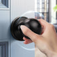 Hand holding KNOBWELL Round Ball Black Passage Door Knobs For Interior
